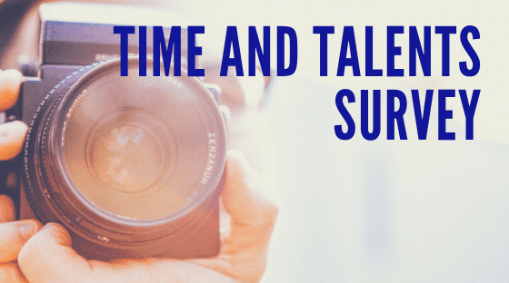 A person holding a camera with the words " time and talent support " written on top of it.